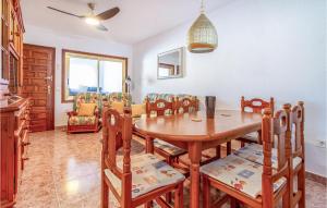 kuchnia i jadalnia z drewnianym stołem i krzesłami w obiekcie Stunning Home In Torrevieja With Wifi w mieście Torrevieja