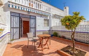 patio ze stołem i drzewem przed budynkiem w obiekcie Stunning Home In Torrevieja With Wifi w mieście Torrevieja +27 zdjęć