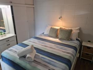 a bedroom with a bed with towels on it at Sea-Hi Beachside Apartment in Maroochydore