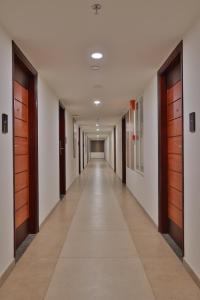 an empty corridor of a hospital with wooden doors at Lagoona Beach Resort in Kovalam
