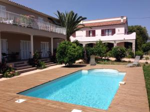 a swimming pool in front of a house at I Casilari in Serra-di-Ferro