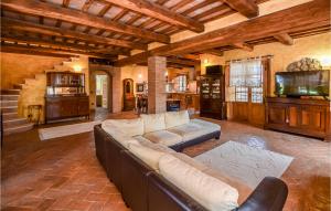 a large living room with a couch and a tv at 3 Bedroom Awesome Home In Civitella Dagliano in Civitella dʼAgliano