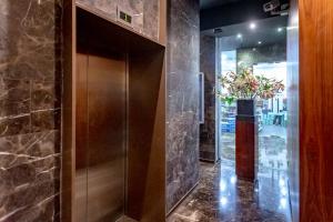 a lobby with a door and a vase of flowers at Rex Ollie @ Myhabitat Condominium in Kuala Lumpur