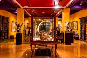 a museum with a display case in the middle of a room at Tanah Merah Art Resort in Ubud