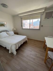a bedroom with a bed and a large window at Mirador San Francisco in Salta