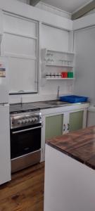 a kitchen with a stove and a counter top at Gingerbread Cottage and Studio Fiji in Savusavu