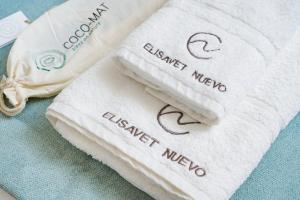 two towels with the words embassy mexico on them at Elisavet Nuevo Studios & Suites in Skala Potamias