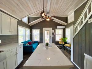 a kitchen and living room with a ceiling at Cozy Tiny Home with Patio - 1 Mile to Town in Fredericksburg