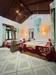 a bedroom with a large bed and a mirror at Tiger Residency Resort in Sauraha