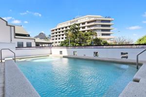a swimming pool in front of a building at Stunning Coastal 3 Bedroom Apartment in Cairns CBD in Cairns