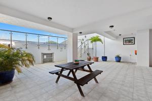 a living room with a table and a fireplace at Stunning Coastal 3 Bedroom Apartment in Cairns CBD in Cairns