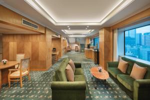 a hotel lobby with green couches and a large window at Crowne Plaza Chengdu City Center by IHG in Chengdu