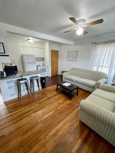 a living room with two couches and a kitchen at Cozy Home in the Heart of Pocatello in Pocatello