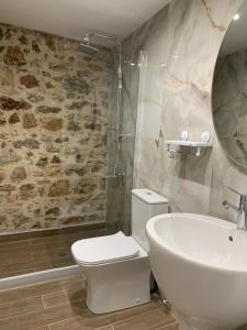 a bathroom with a white toilet and a sink at 1830 Chateau in Nafplio