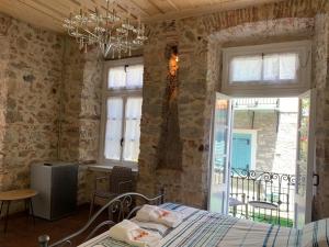 a bedroom with a bed and a chandelier at 1830 Chateau in Nafplio
