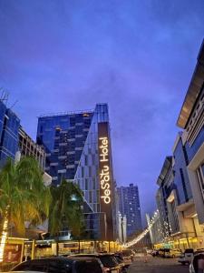 a building with a sign on the side of it at Desatu Hotel in Medan