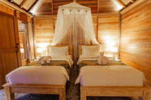Postel nebo postele na pokoji v ubytování Nauna Villa Ubud