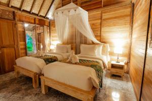 Postel nebo postele na pokoji v ubytování Nauna Villa Ubud
