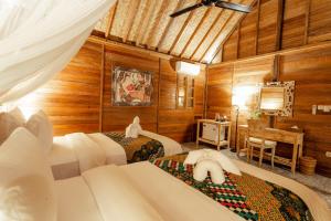 Postel nebo postele na pokoji v ubytování Nauna Villa Ubud