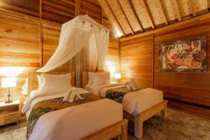 Postel nebo postele na pokoji v ubytování Nauna Villa Ubud