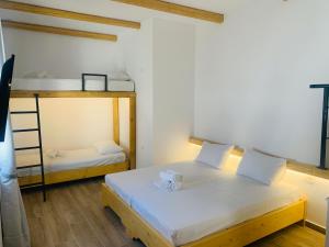 a room with two beds and a bunk bed at il Centro in Ios Chora