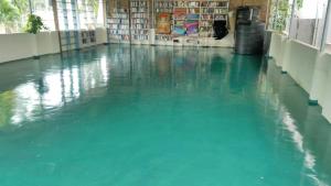 a large pool of water in a room with a floor at Marina guest house in Kovalam