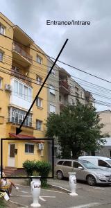 a picture of a building with two vases in a parking lot at APARTAMENT NOBLESS No1 ALBA IULIA in Alba Iulia
