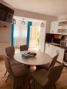 a kitchen with a table and chairs in a kitchen at APARTAMENT NOBLESS No1 ALBA IULIA in Alba Iulia