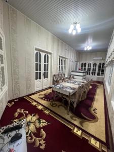 una grande sala da pranzo con tavolo e sedie di Bruce hostel a Dushanbe