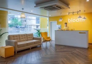 a man sitting at a counter in an office lobby at Bloom Hotel - HITEC City in Hyderabad