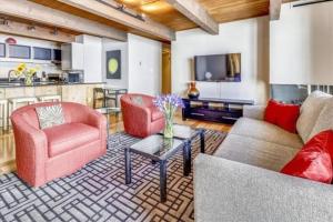 a living room with two couches and a tv at Luxury 2 Bedroom Mountain Vacation Rental In The Heart Of Downtown Aspen One Block From Silver Queen Gondola in Aspen