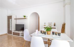 a white dining room with a white table and white chairs at Cozy Apartment In Torrevieja With Wifi in Torrevieja