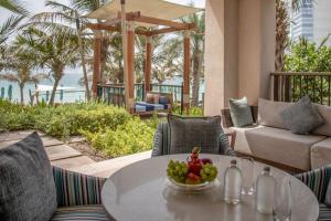 a table with a bowl of fruit on a patio at Jumeirah Al Naseem Dubai in Dubai