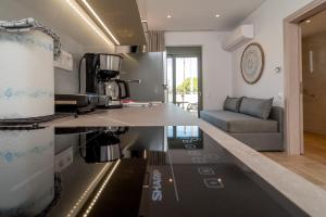 a kitchen with a counter and a couch in a room at Evriali Comfort Living in Palaiochóra +68 photos