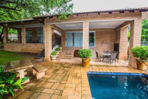 a house with a swimming pool and a patio at @Home Guest House in Rustenburg