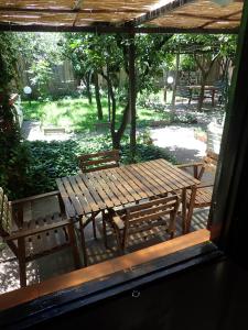 a wooden bench sitting under a pergola at Capricornio Club in Maiori