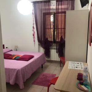 A bed or beds in a room at Casa Tognetti Affittacamere