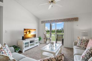 a living room with a couch and a tv at Vista Verde North 5-231, 2 Bedrooms, Sleeps 6, Golf View, Heated Pool, Spa, WiFi in St. Petersburg