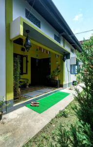 a house with a green lawn in front of it at Stargaze Backpackers Hostel in Guwahati