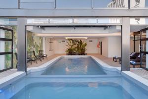 a large swimming pool in a building at Lovely 2 bedroom rental unit close to the V&A Waterfront in Cape Town