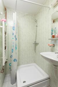 a bathroom with a shower and a toilet and a sink at Apartments Castanea in Sarajevo