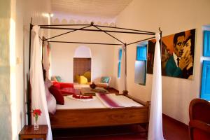 a bedroom with a canopy bed in a room at The House of Royals in Zanzibar City
