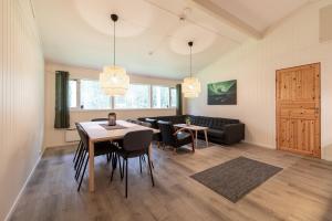 a living room with a table and chairs and a couch at Høgtun kulturklynge in Olsborg