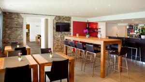 a dining room with wooden tables and chairs at Hotel Collinetta in Ascona