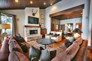 a living room with a couch and a fireplace at Premium Luxury Three Bedroom Suite with Two Hot Tubs apartment hotel in Park City