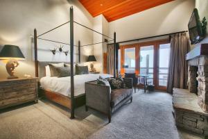 a bedroom with a canopy bed and a fireplace at Premium Luxury Three Bedroom Suite with Two Hot Tubs apartment hotel in Park City