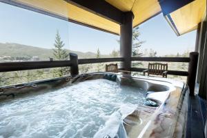 a jacuzzi tub in a house with a view at Premium Luxury Three Bedroom Suite with Two Hot Tubs apartment hotel in Park City