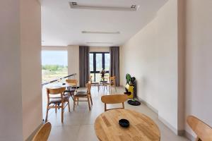 a living room with a table and chairs at JAP KARO in Tan An