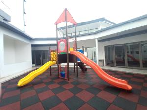 a playground with two slides in a building at Cozy Homestay at Palas Horizon @ Kea Farm/6 pax in Brinchang