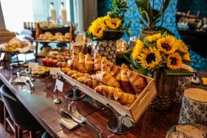 a long table with a bunch of croissants and bread at InterContinental Cascais-Estoril by IHG in Estoril